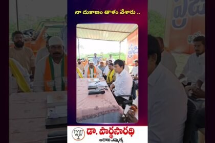 MLA Dr. Parthasarathi speaking with elderly couple Mohammad Zakariya and Naseem Begum about their locked shop and livelihood struggle